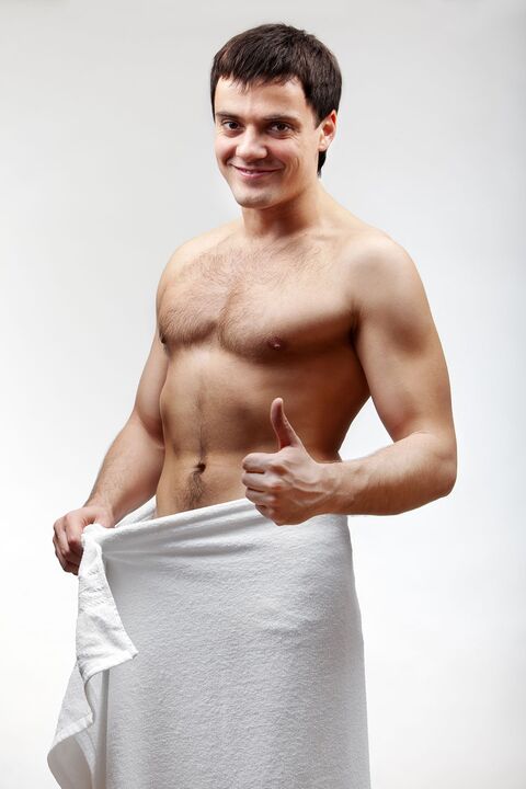 Man in towel is satisfied with his penis enlargement